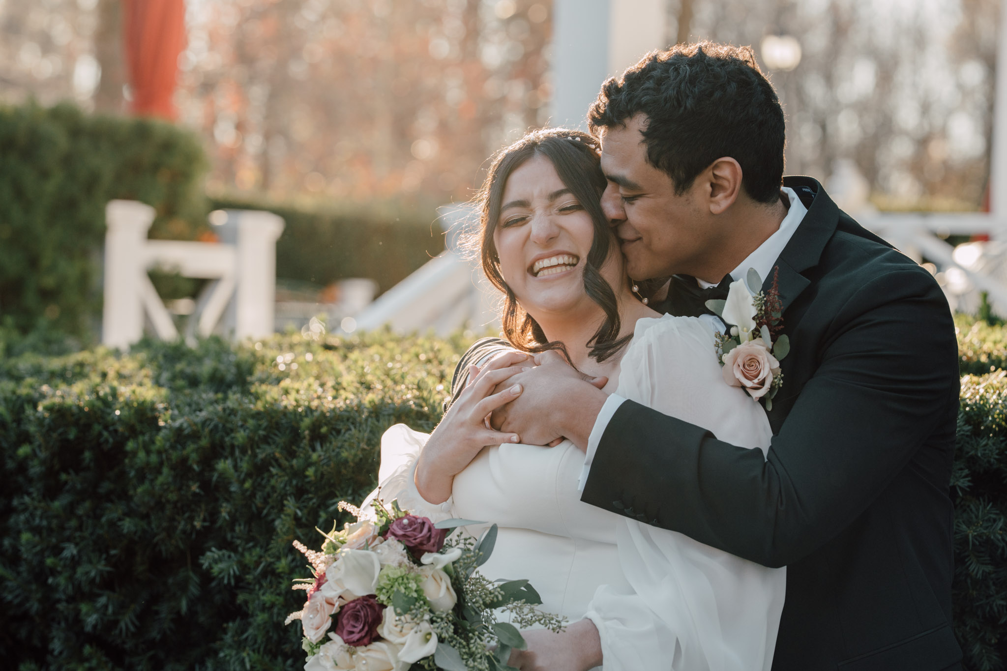 A groom embracing his laughing bride at Curry Estate, Hopewell Junction, New York