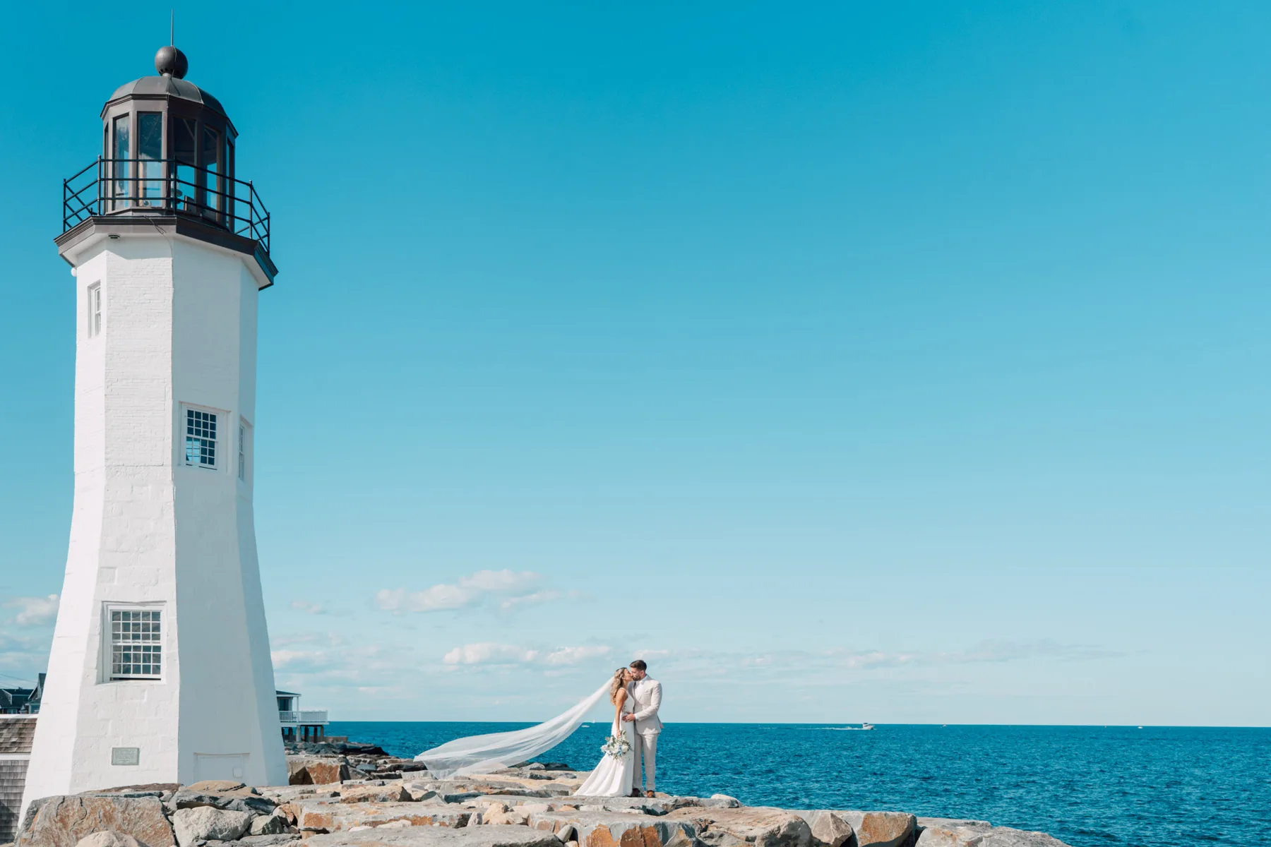 A couple beside a New England lighthouse