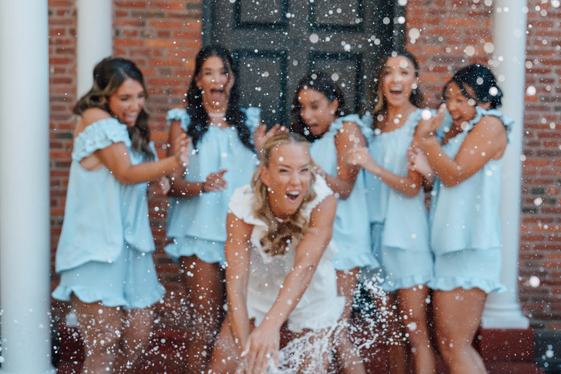 A bride and bridesmaids celebrating together