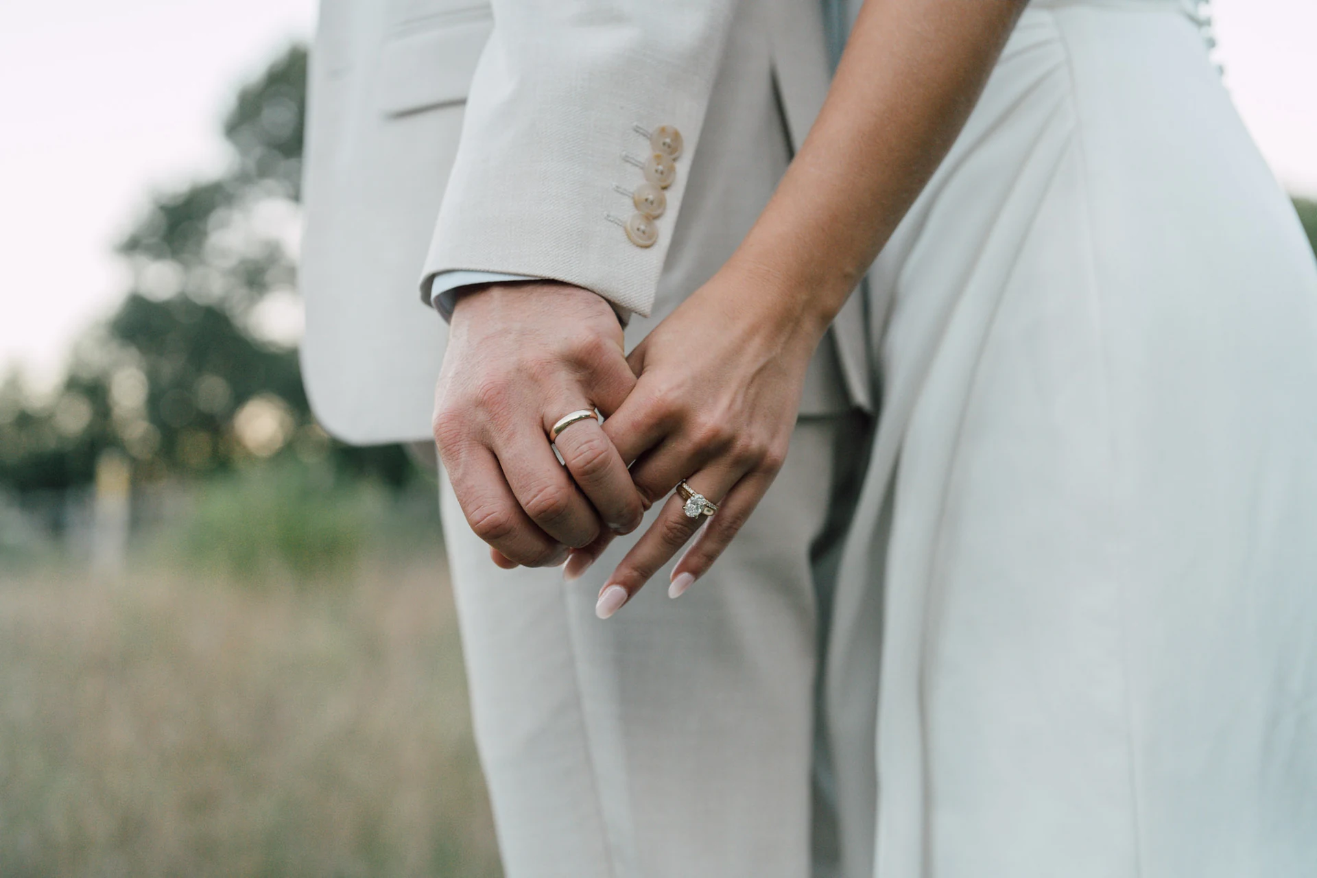 A close-up of newlyweds' hands and wedding rings at The Barn at Bradstreet Farm, Rowley, Massachusetts