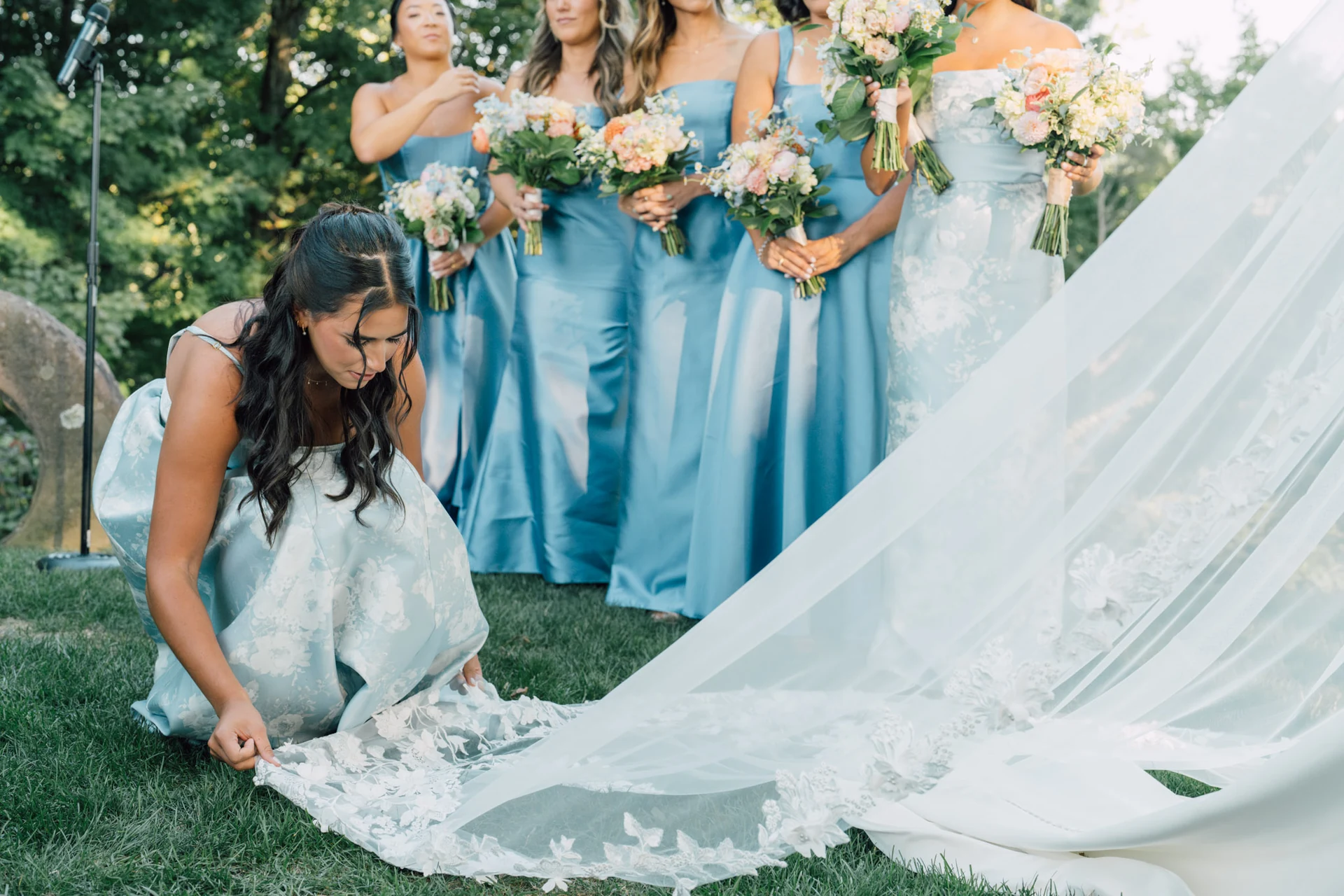 A bridesmaid arranging the bride's dress during the ceremony at Saint Clements Castle, Portland, Connecticut